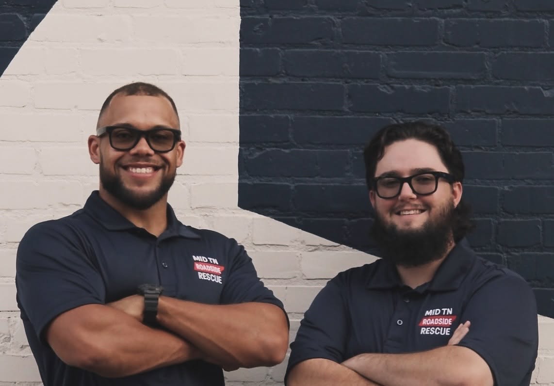 Two MID TN ROADSIDE RESCUE team members in branded polo shirts